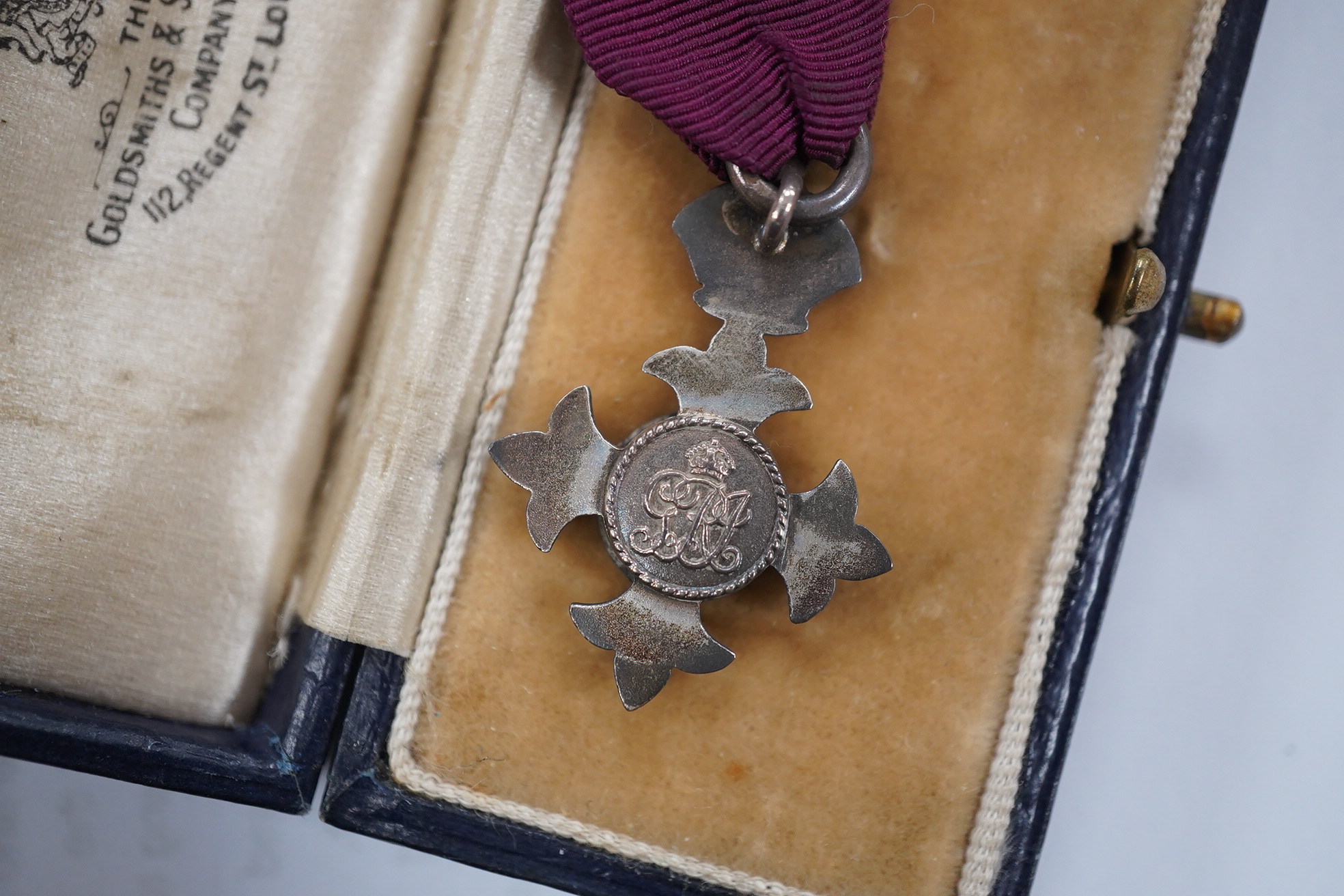 A cased George V military MBE containing leaflet with instructions as to wearing Insignia, together with the separately cased miniature. Condition - fair to good